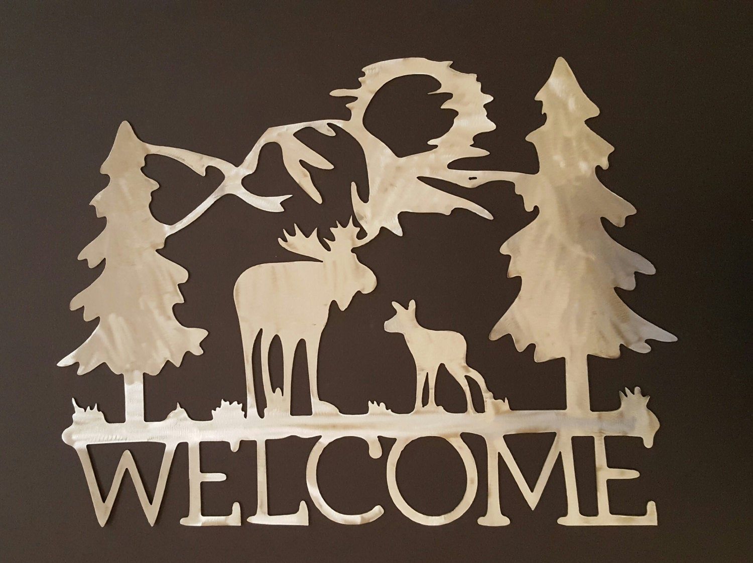 Metal Welcome Sign With Moose Mountains And Pine Trees (View 14 of 20)