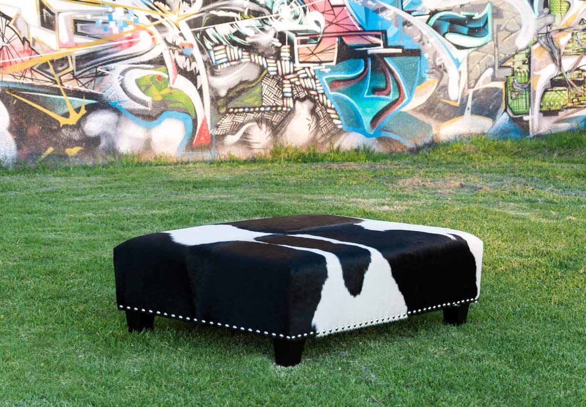 A Classic Black And White Cowhide Ottoman With Studsgorgeous With Black Leather And Gray Canvas Pouf Ottomans (View 20 of 20)