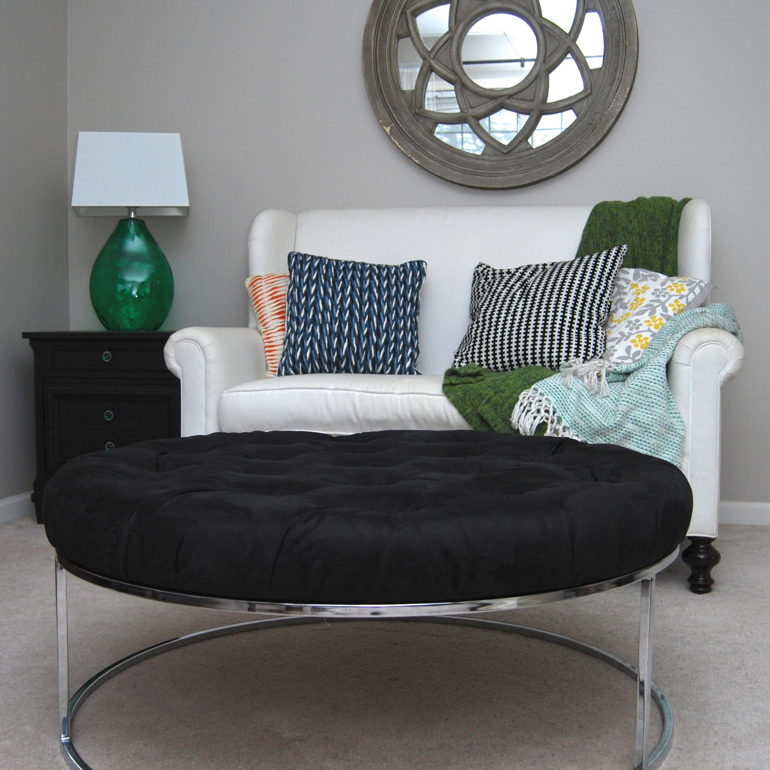 A Round, Black Tufted Ottoman With A Chrome Base – The Weathered Door In Weathered Wood Ottomans (View 5 of 20)