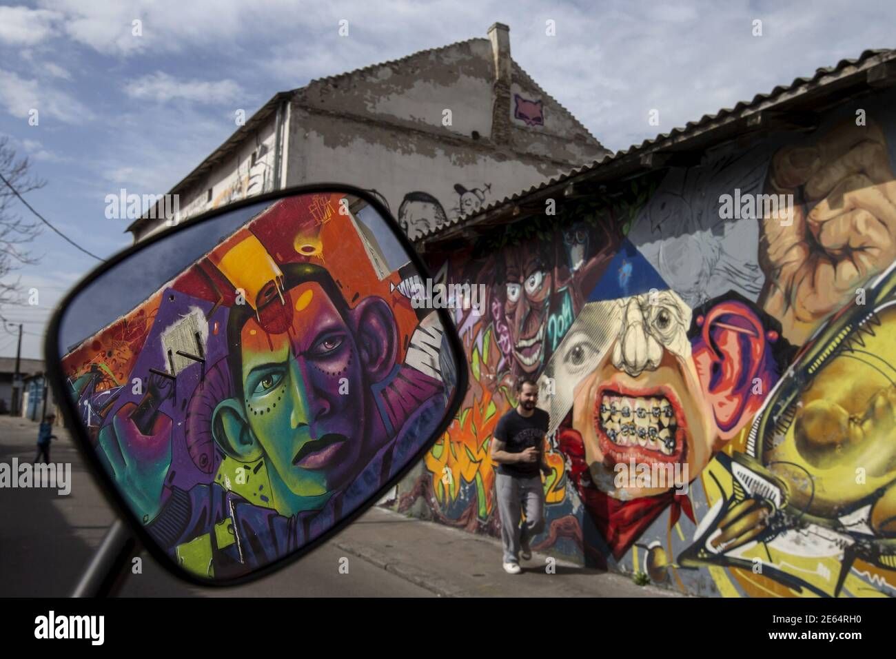 A Man Walks Past A Wall Mural In Savamala District In Belgrade March 26,  2015. The Vista Of Rusting Boats And Drab Wasteland That Greets Visitors  Passing Over The River Sava Into For Current Summer Vista Wall Art (Gallery 20 of 20)